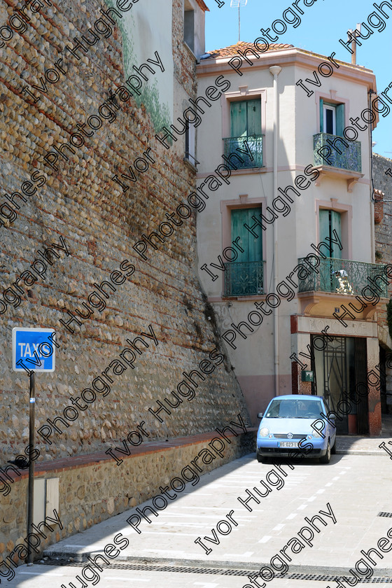 D3N 7674 
 Keywords: Elne Illiberis town village images Languedoc Roussillon 66 France Pyrenees ancient capital city French building street road traffic direction shop signs attention taxis