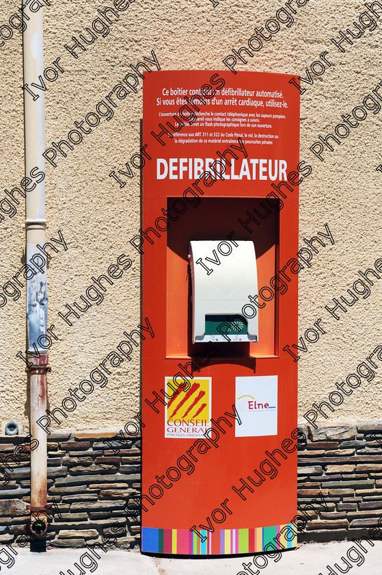 D3N 7690 
 Keywords: Elne Illiberis town village images Languedoc Roussillon 66 France Pyrenees ancient capital city French building street road traffic direction shop signs attention defibrillator