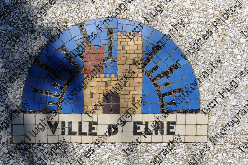 D3N 7623 
 Keywords: Elne Illiberis town village images Languedoc Roussillon 66 France Pyrenees ancient capital city French building street road traffic direction shop signs attention mosaic town motif