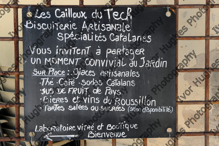 D3N 7647 
 Keywords: Elne Illiberis town village images Languedoc Roussillon 66 France Pyrenees ancient capital city French building street road traffic direction shop signs attention biscuit maker beers ice cream caf menu