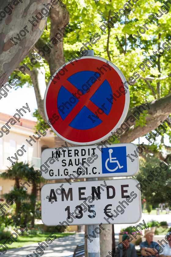 D3N 7595 
 Keywords: Elne Illiberis town village images Languedoc Roussillon 66 France Pyrenees ancient capital city French building street road traffic direction shop signs attention disabled parking fine 135 euros penalty