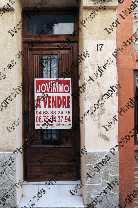 D3N 7645 
 Keywords: Elne Illiberis town village images Languedoc Roussillon 66 France Pyrenees ancient capital city French building street road traffic direction shop signs attention house for sale sign